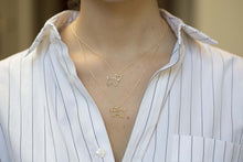 Load image into Gallery viewer, Gold chain necklace with dog shaped pendant and small diamond worn by model