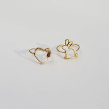 Load image into Gallery viewer, Gold rings shaped like a heart with a garnet baguette stone and a little rabbit