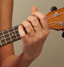 Load image into Gallery viewer, Gold seated cat shaped ring worn by model playing guitar
