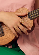 Load image into Gallery viewer, Hand playing guitar wearing gold rings