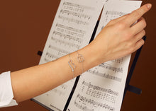 Load image into Gallery viewer, white gold chain bracelets with dinosaur and house shaped pendants