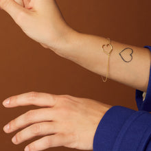 Load image into Gallery viewer, Gold chain bracelet with heart shaped pendant worn by model