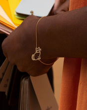 Load image into Gallery viewer, Gold chain bracelet with seated cat shaped pendant worn by model