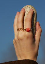 Load image into Gallery viewer, Hand wearing a crocodile shaped gold ring with diamond and a gold ring with a shell in red coral