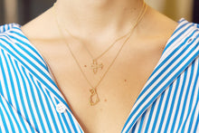 Load image into Gallery viewer, Gold chain necklaces with airplane and cat shaped pendants worn by model