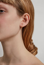 Load image into Gallery viewer, Model wearing a mini gold hoop earring