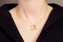 Load image into Gallery viewer, Woman wearing two gold necklaces with shrimp and whale shaped pendants with blue sapphire