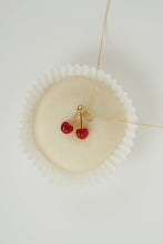 Load image into Gallery viewer, Creamy white pastry with a necklace with coral cherries as pendant on top
