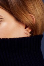 Load image into Gallery viewer, Woman wearing a small rabbit shaped gold earring with a pearl tail
